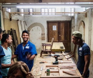 Students restoring a chair at the Escuela Taller Workshop School